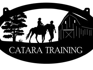 Metal sign with horse rider and barn